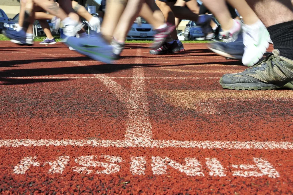 People in an Olympic stadium about to start running